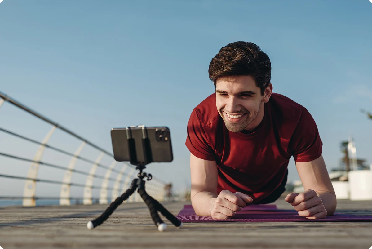 Un hombre haciendo ejercicio mientras se graba con el móvil.