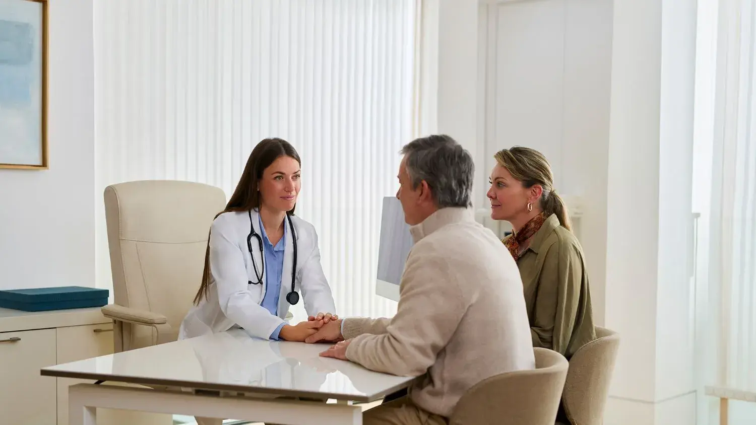 doctora en clinica atendiendo a una pareja